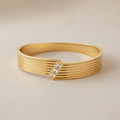 Gold Cuff Bracelet with Ridged Texture and Crystal Accent